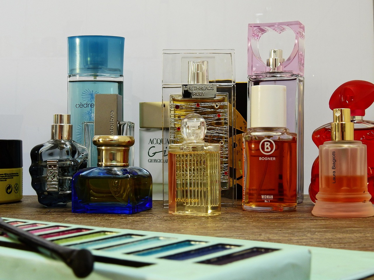 Bathroom before a Whisk clean: vanity cluttered with perfume bottles and makeup